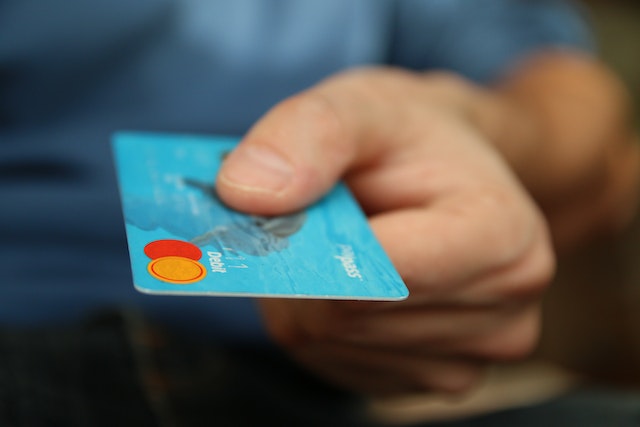 person holding bank payment card